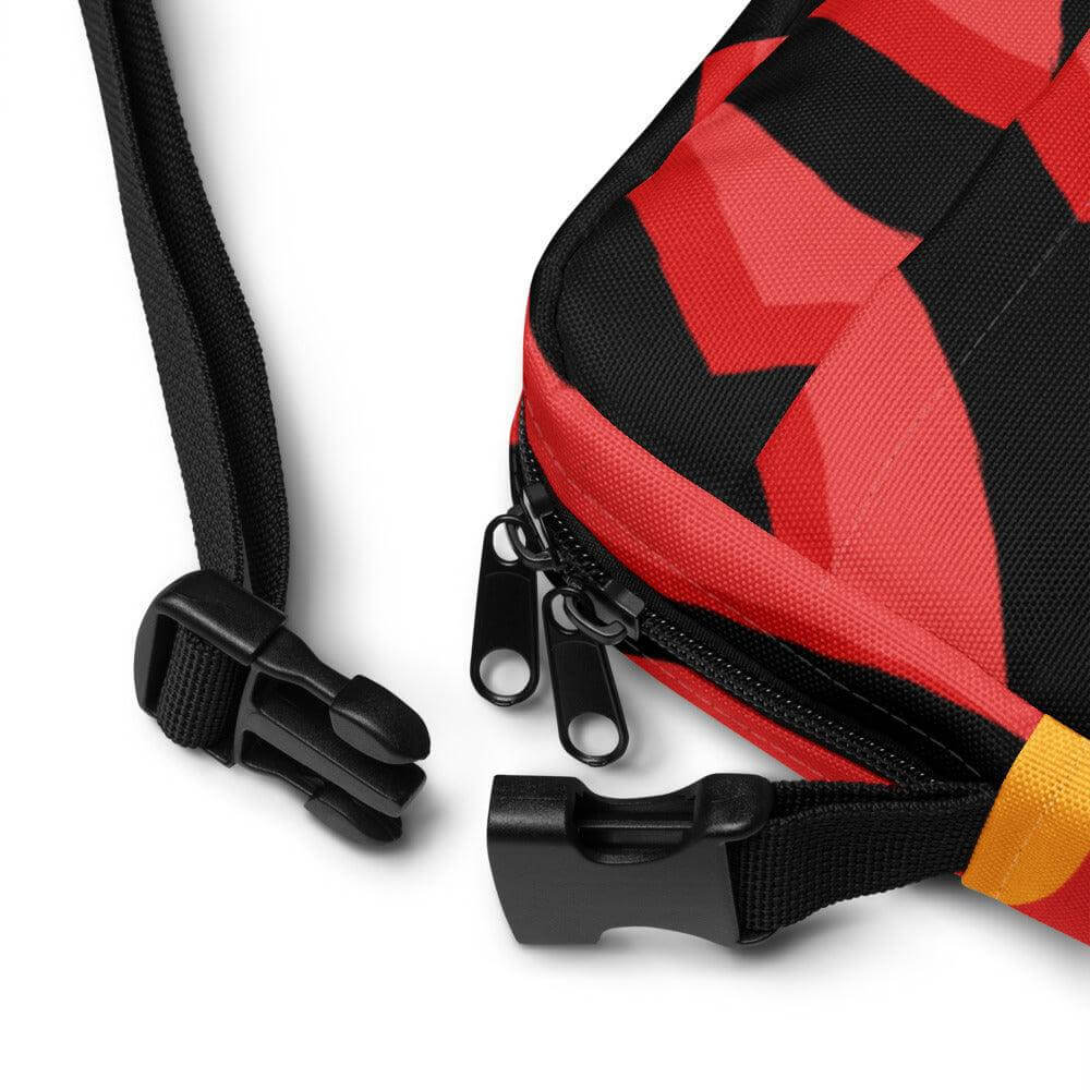 Close-up of adjustable straps and zippers on Hora Mágica Utility Crossbody Bag in red and black.