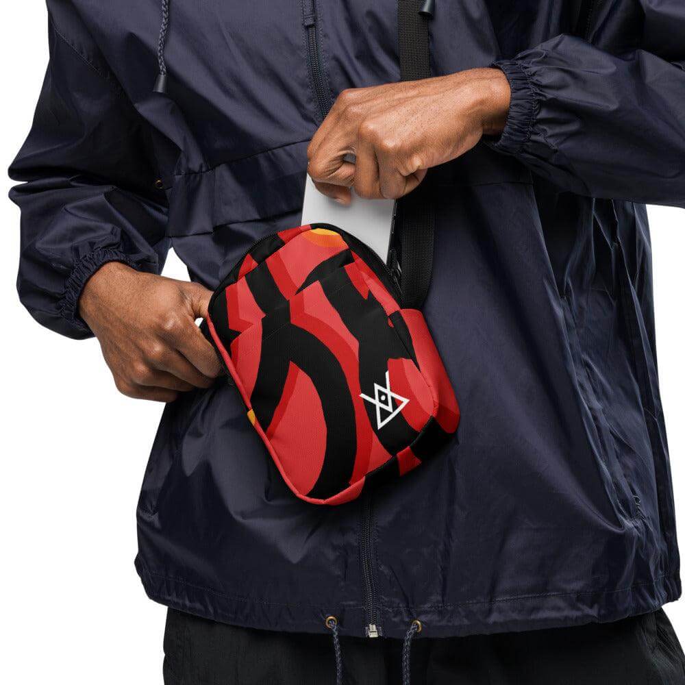 Person using adjustable Hora Mágica Utility Crossbody Bag with two spacious pockets for essentials, wearing navy jacket.