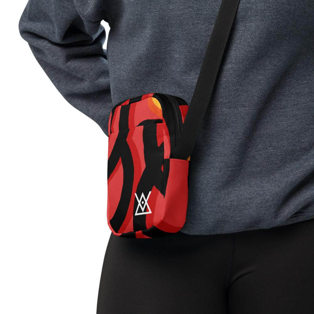 Person wearing Hora Mágica Utility Crossbody Bag with adjustable straps and vibrant design for adventures and daily use.