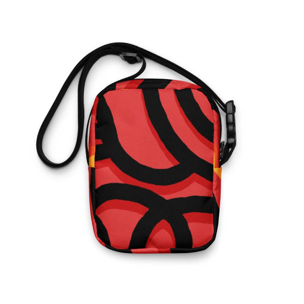 Hora Magica Utility Crossbody Bag with red and black abstract design, adjustable strap, and spacious pockets for essentials. Ideal for adventures.